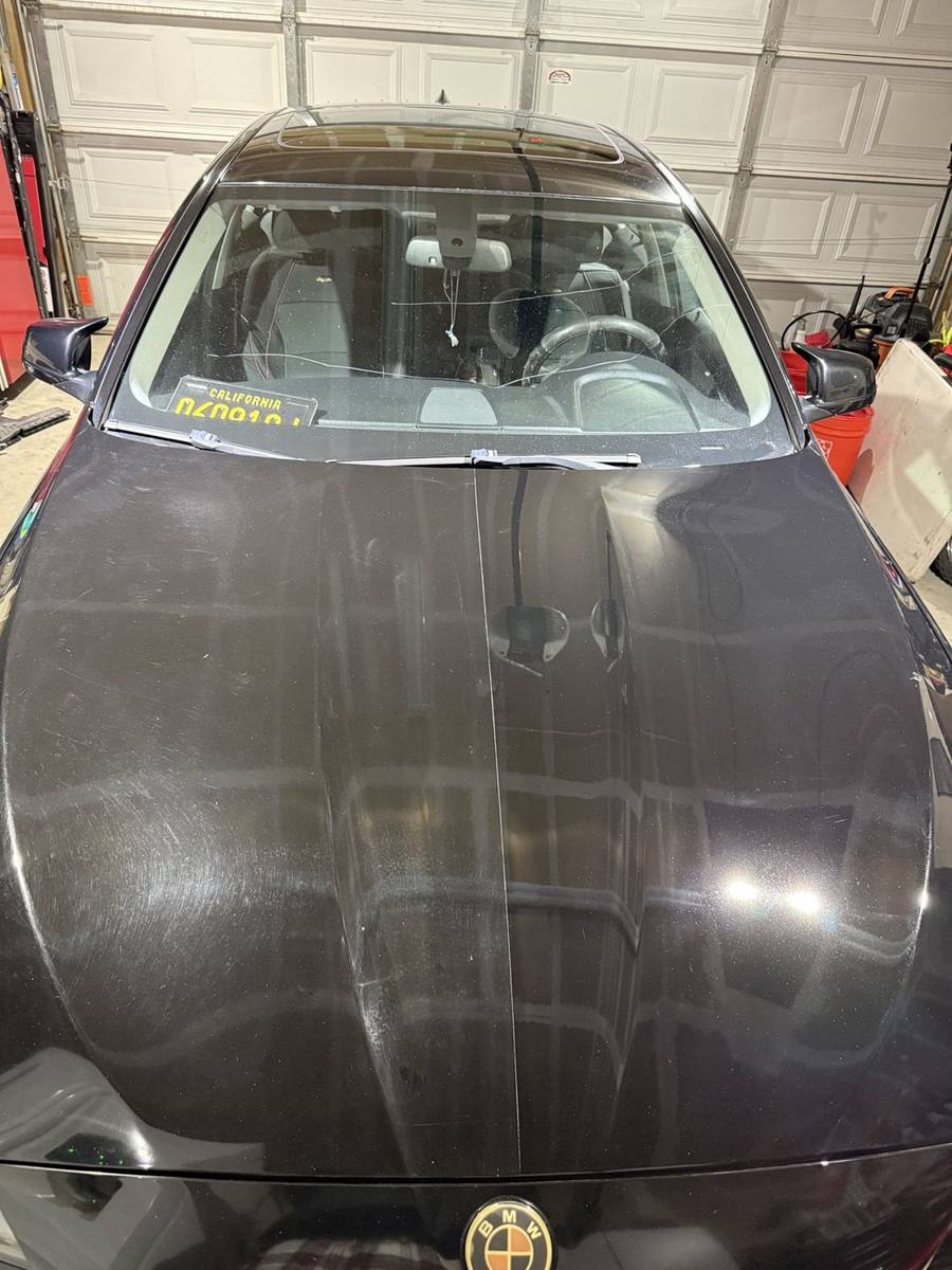 Black BMW hood, 50/50. Half corrected, half untouched, to show the difference