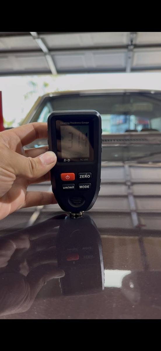 Measuring paint in mils. Checking paint thickness on the 1970 Caprice with a coating gauge before correction
